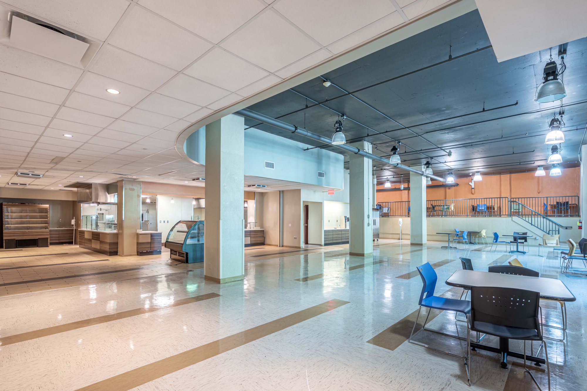 Large open common area with seating, counters, and a mezzanine